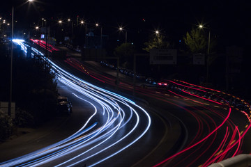 View of car streak lights at night near the airport of Faro city, Portugal.