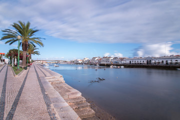 Obraz premium Wide view of the picturesque city of Tavira, Portugal, crossed by Gilao river.