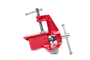 Close up view of a metal table vise clamp isolated on a white background.