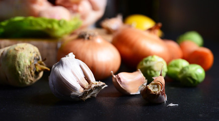 Raw onion garlic on black table