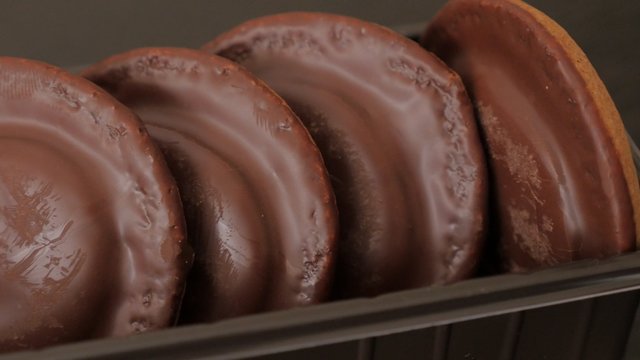 Chocolate glazed orange biscuits in plastic package slow panning 4K 2160p UltraHD footage - Slow panning over biscuit package 4K 3840X2160 UHD video
