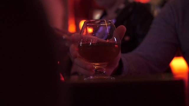brandy glass, cognac. table, hand.