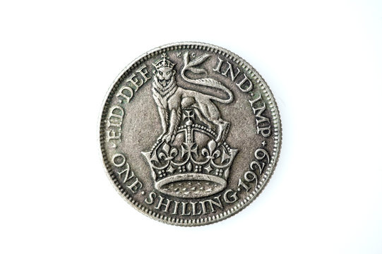 George V silver English shilling, which is now an obsolete coin of England, UK. It's value was twelve pence, one twentieth of the pound at that time