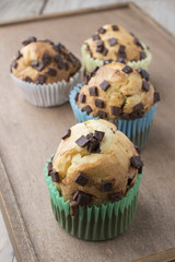 Muffins with chocolate on a wooden table