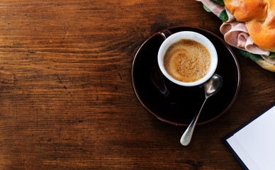 Cup of coffee espresso over dark wooden surface.