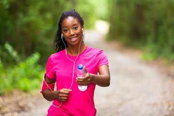  African american woman jogger holding a water bottle  - Fitness