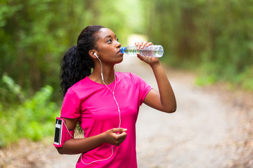  African american woman jogger drinking water  - Fitness, people