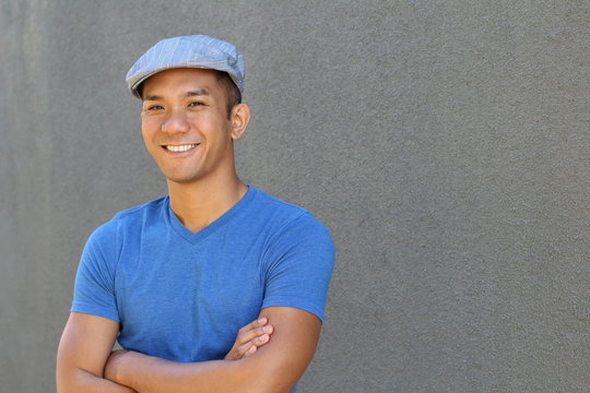 Portrait Of A Smiling Asian Man In Newsboy Hat Looking To Camera