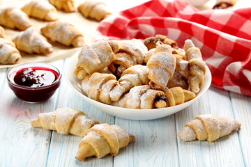 Fresh homemade croissants on a blue wooden table