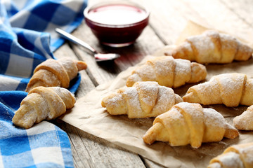 Fresh homemade croissants on a grey wooden table