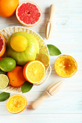 Citrus fruits with juicer on a blue wooden table