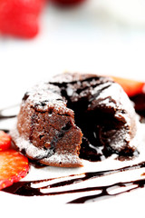 Chocolate fondant with strawberry on blue wooden table