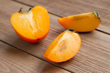ripe persimmon on a wooden background