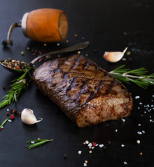 Grilled beef steak with spices, garlic and rosemary