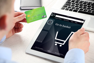 Man shopping online with digital tablet