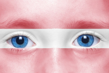 human's face with latvian flag