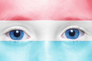 human's face with luxembourg flag