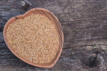 Wooden heart dish with flax seeds