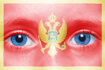 human's face with montenegro flag