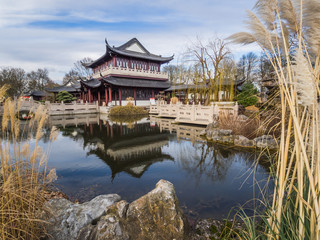 Fototapeta na wymiar lake in front of a japanese style house