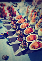 Spoons with seafood snacks, toned