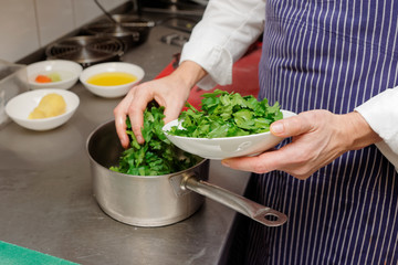 Chef is cooking a parsley sauce