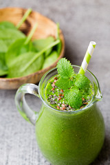 Spinach smoothie, on the grey  background.