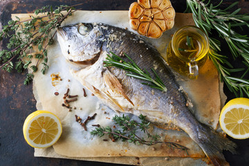 Grilled fish sea bream with aromatic spices, herbs and lemon