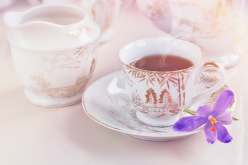 cup of tea or coffee and crocus flowers