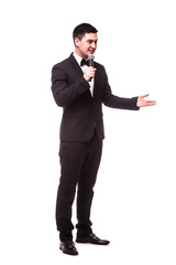 Young Showman present invisible product or advertising  with microphone against white background.Showman concept. - obrazy, fototapety, plakaty