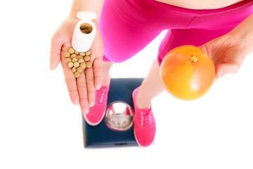 Obraz premium Woman holding vitamins and apple. Health care.
