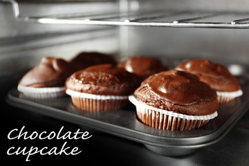 Chocolate cup-cakes in oven, close up