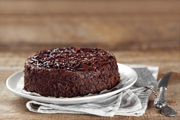 Fototapeta na wymiar Tasty chocolate cake on wooden background