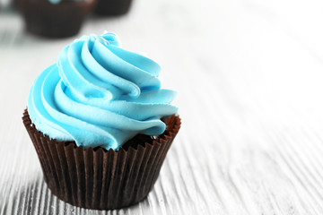 Blue cupcakes on wooden table