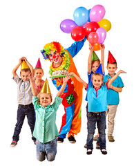 Clown keeps bunch of balloons and birthday cake with group children. Isolated.