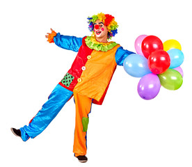 Happy cheerful birthday clown keeps  bunch of balloons and is dancing.  Isolated.
