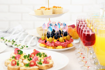 Set of cold snacks, canape, beverages, closeup