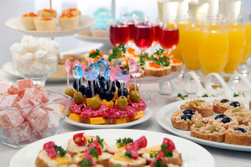 Set of cold snacks, canape, beverages and dessert, closeup