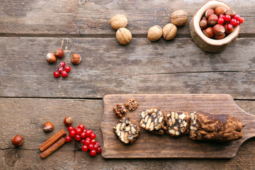 Chocolate salami on a chopping board over wooden background