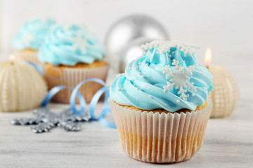 Few tasty blue cupcakes with decorations on light background