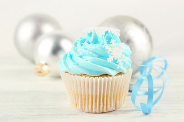 Tasty blue cupcake with decorations, closeup