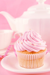 Tasty cupcakes with tea set and decorations, closeup