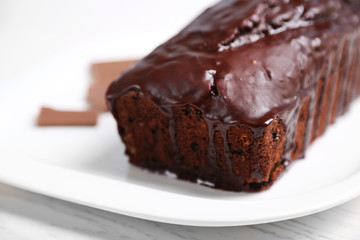 Chocolate cake with icing on white table