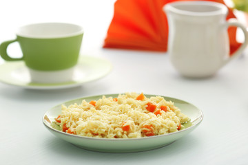 Stewed rice with a carrot on a plate