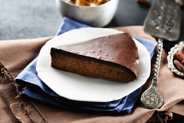 Piece of frosting chocolate cake on white plate