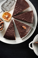 Pieces of frosting chocolate cake on black table