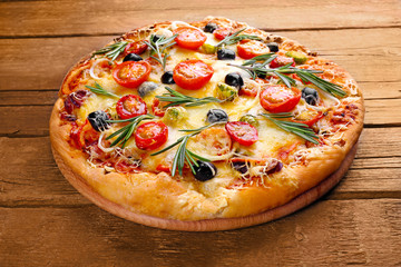 Delicious fresh pizza on wooden background