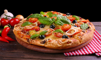 Delicious fresh pizza on black background