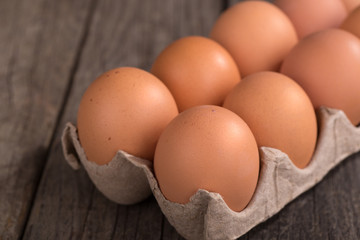 Brown Eggs in an Egg Carton on a Wooden Surface