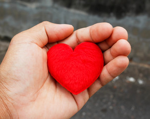 Obraz premium Hand hold red heart for love ,valentine concept vintage color tone.